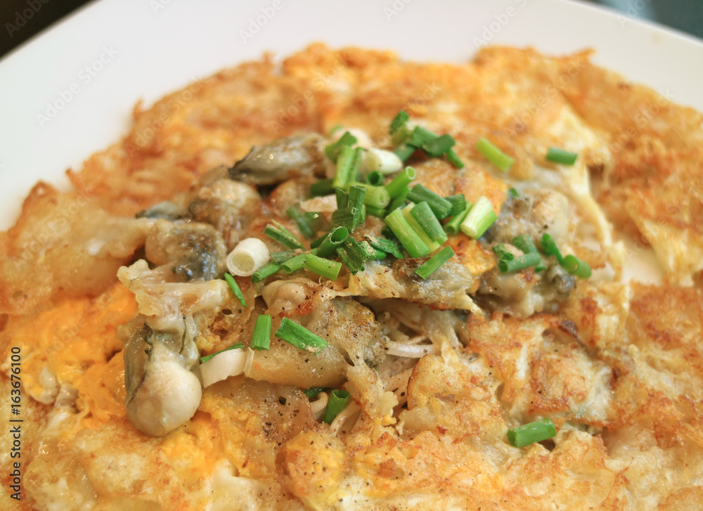 Close-up of fried oysters with crispy omelette topped with chopped spring onion Close-up of fried oysters with crispy omelette topped with chopped spring onion