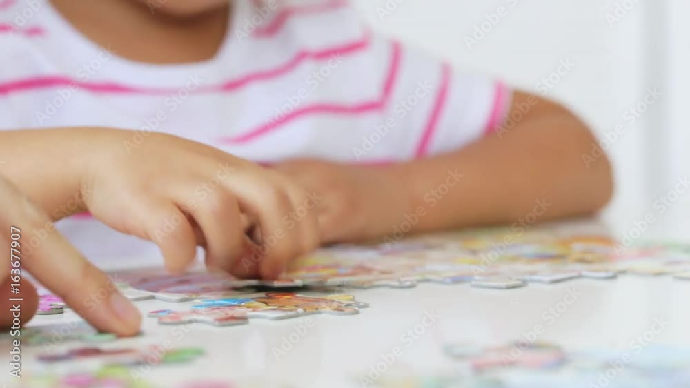 Mother and daughter doing a puzzle together in the light living room Mother and daughter doing a puzzle together in the light living room