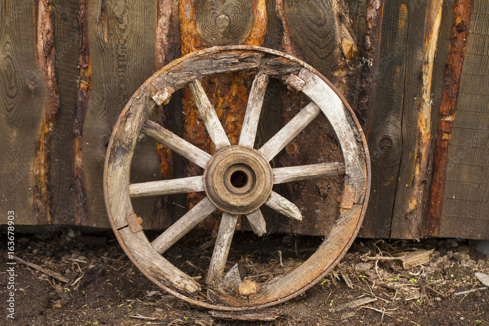 Old wooden wheel for a horse carriage