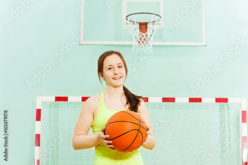 Pretty teen girl with ball during basketball game © Sergey Novikov