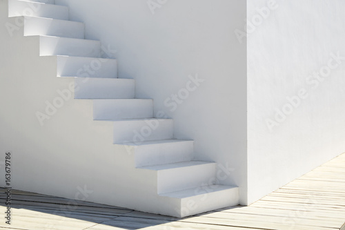 Detail of a white stairway in a sunny day