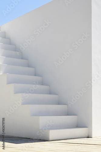 Detail of a white stairway in a sunny day