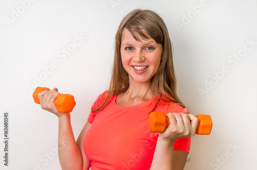 Fitness woman doing exercises with dumbbells