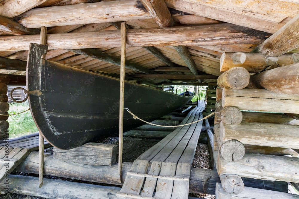 Ancient boat house made of tree logs