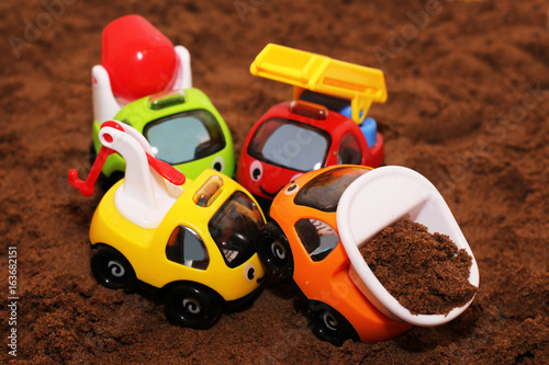 The toy car on the sand.