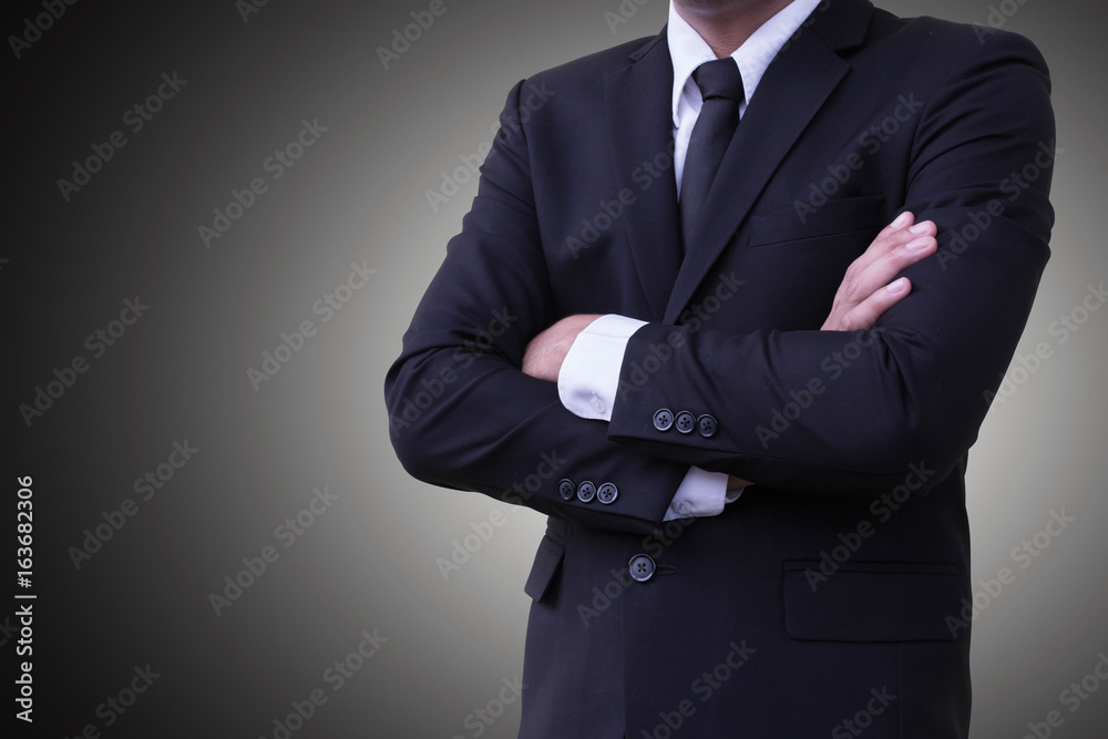 Business personality standing arms crossed Wear a suit On a gray background or backdrop Business personality standing arms crossed Wear a suit On a gray background or backdrop