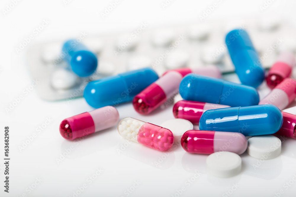 pile of medical pills and blue pills on background pile of medical pills and blue pills on background