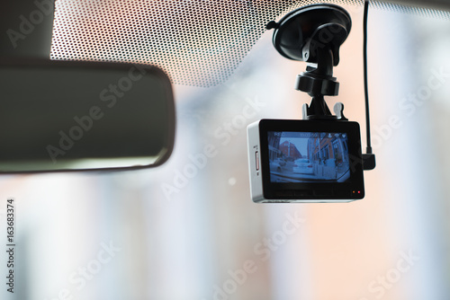 фотографія A car dash cam mounted on the front windshield recording the traffic ahead in ca
