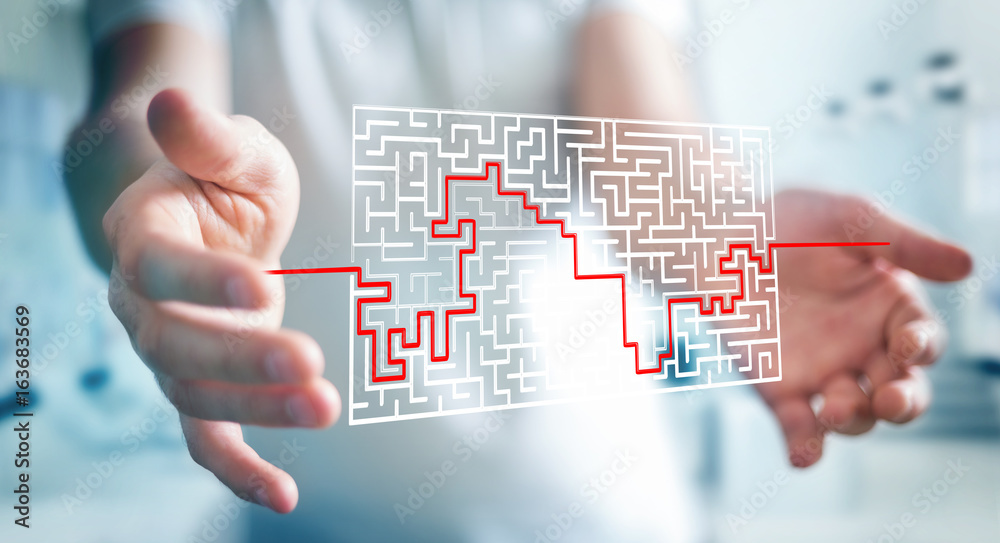Businessman searching solution of a complicated maze Businessman searching solution of a complicated maze