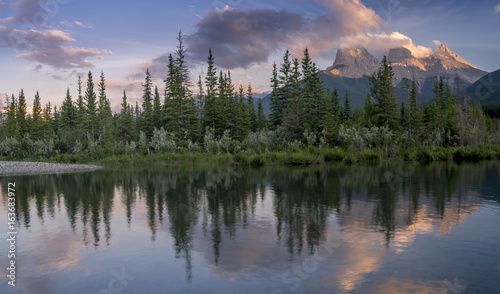 Three Sisters at sunset along the Bow River in Alberta Canada