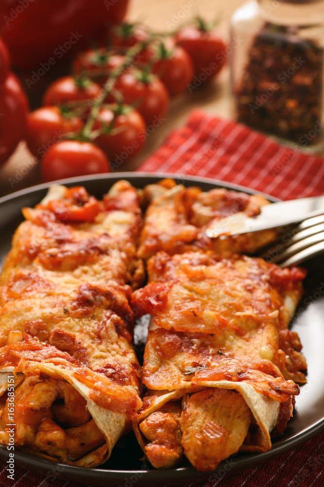 Enchiladas - mexican food, tortilla with chicken, cheese and tomatoes. Enchiladas - mexican food, tortilla with chicken, cheese and tomatoes.