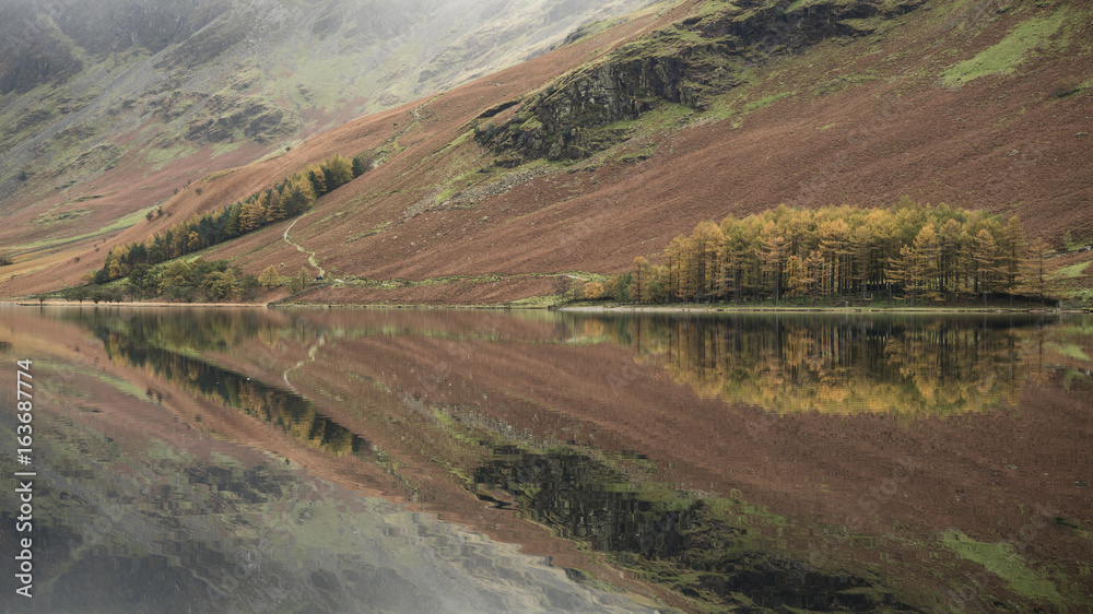 Stuning Autumn Fall landscape image of Lake Buttermere in Lake District England Stuning Autumn Fall landscape image of Lake Buttermere in Lake District England