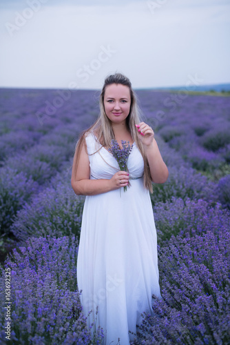 Young girl in white dress in lavender field