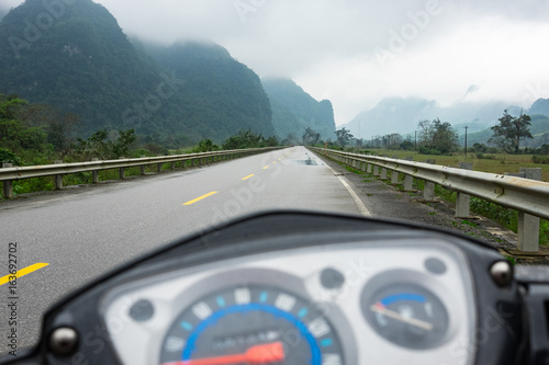 Ho Chi Minh Highway. Vietnam, serpentine road in the mountains, National Park Phong Nha Kẻ Bàng. UNESCO. The rainy season, cloudy, wet asphalt. , traveling a motorbike.