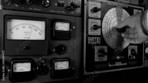 RADIO OPERATOR ADJUSTS VINTAGE EQUIPMENT