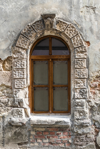 Old window on ancient wall