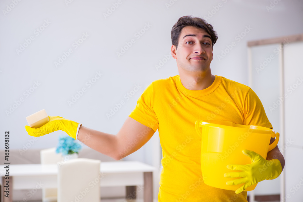 Young man doing chores at home Young man doing chores at home
