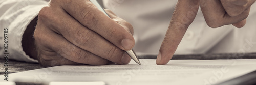 Foto Showing new business partner where to sign an agreement