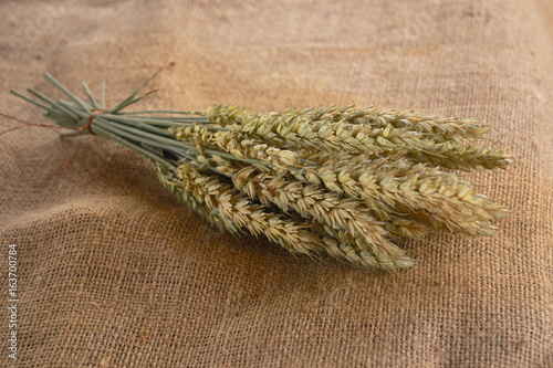 Ears of wheat on a linen tablecloth
