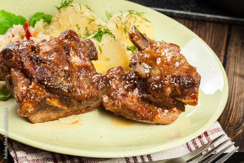 Pork spare ribs served with mashed potatoes and sauce
