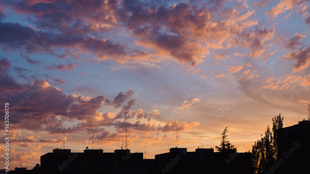 Fototapeta premium Colorful sunset clouds over apartments buildings in Madrid