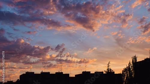 Colorful sunset clouds over apartments buildings in Madrid