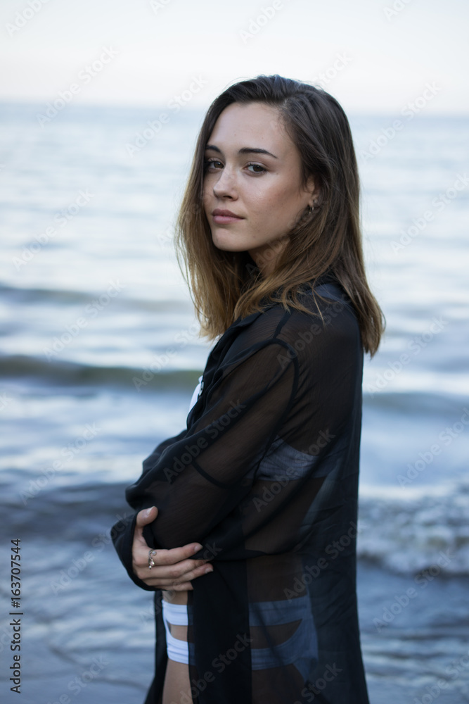 Young sensual woman posing on beach Young sensual woman posing on beach