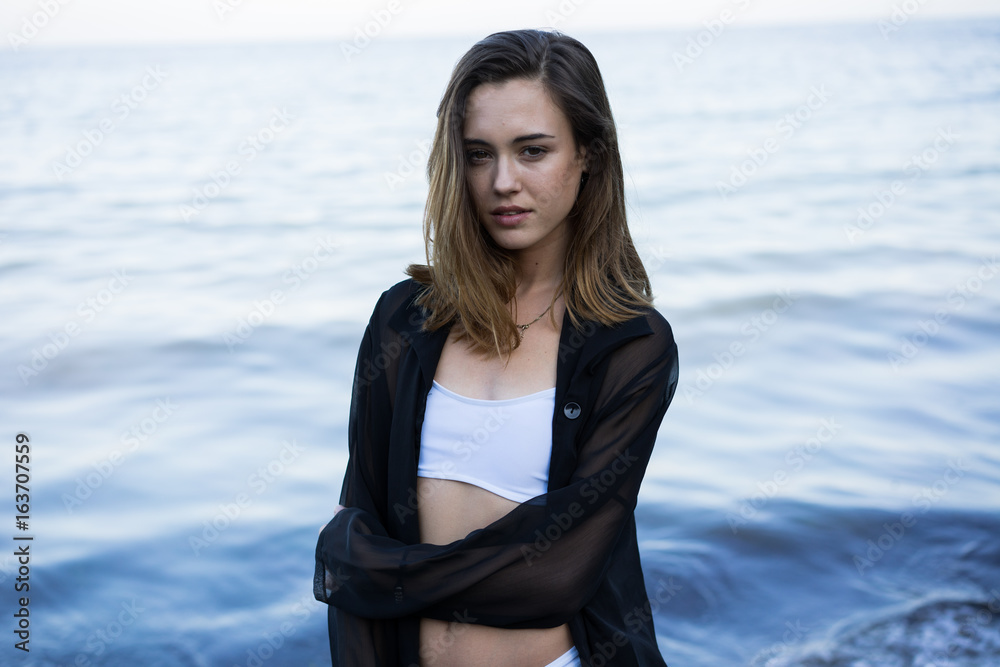 Portrait of a young woman posing on beach Portrait of a young woman posing on beach