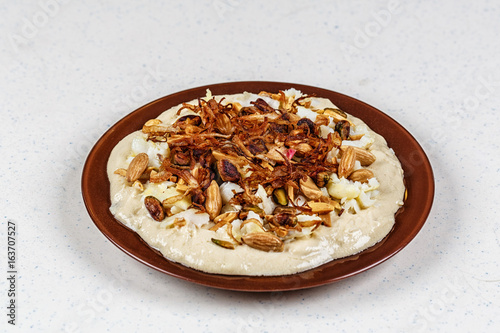 Hummus with olive oil and nuts photo