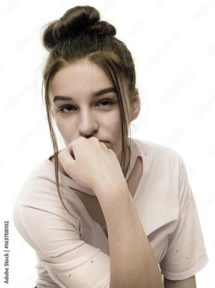 Moody teenage girl looking at camera Moody teenage girl looking at camera