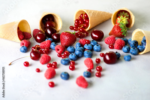 berries poured out from cones on a gray table