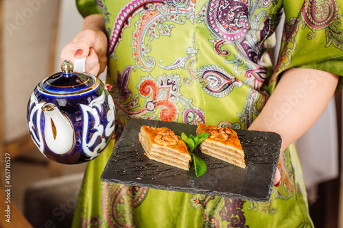 hand holding Piece of baklava sweets photo