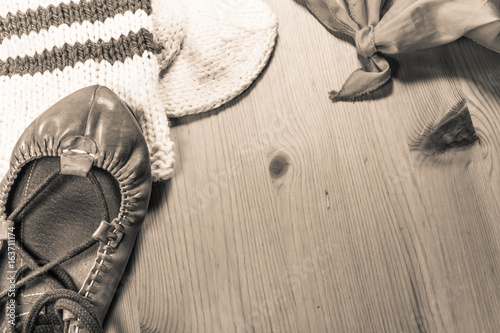 symbol of basque holiday summer festival with scarf, abarka shoe and wool sock on wooden background in sepia photo