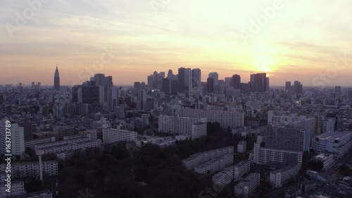 Japan Tokyo Aerial v57 Flying low over Shinjuku area panning with cityscape views at sunset photo