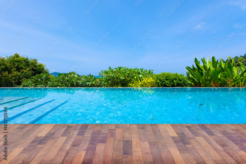 Swimming pool overlooking view andaman sea mountains and blue sky background,summer holiday background concept. - obrazy, fototapety, plakaty 