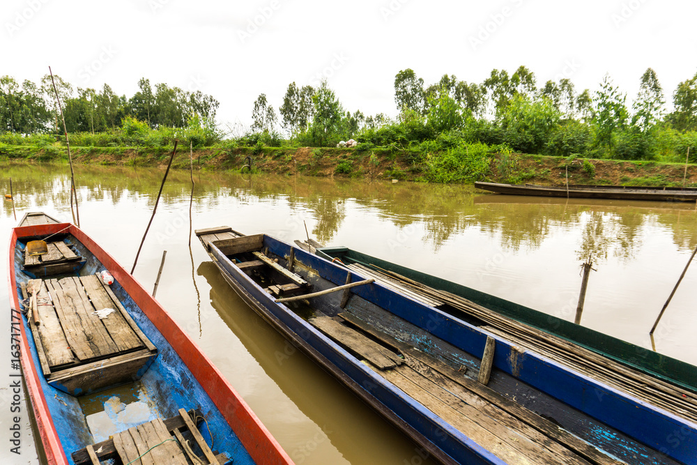 Long tail boat in Thailand's muddy clear waters with morning sunshine.