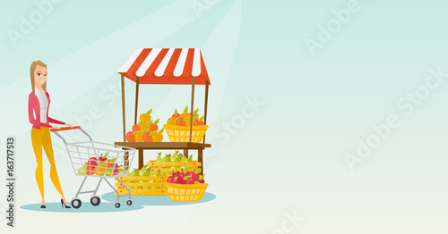 Young caucasian woman pushing a supermarket cart.