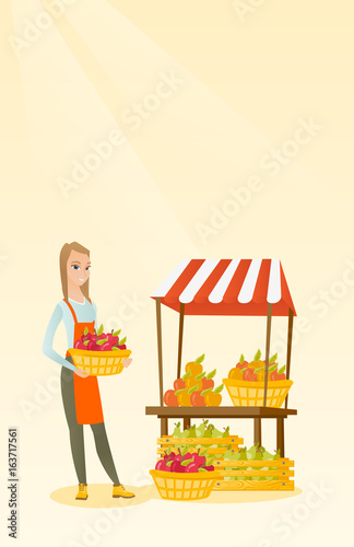 Greengrocer holding box full of apples.
