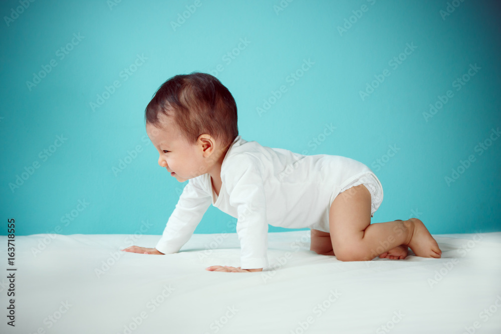Side view of pretty crawling newborn (soft focus on the eyes)
