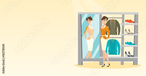 Caucasian woman trying on jacket in dressing room