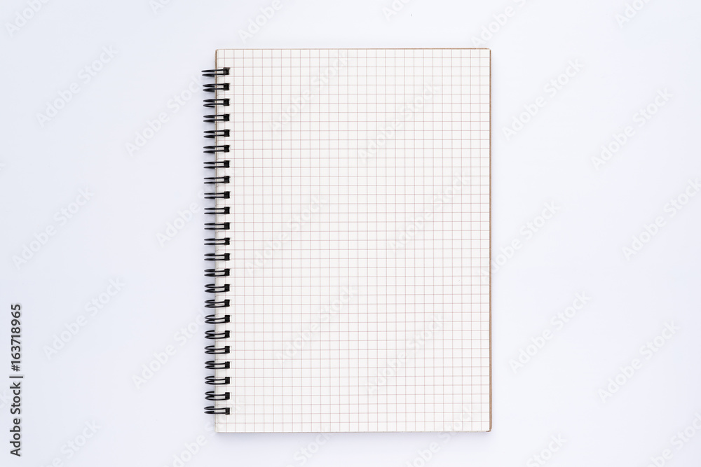 Grid pattern notebook with spiral on white background Grid pattern notebook with spiral on white background