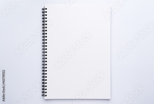 blank white spiral notebook on white background