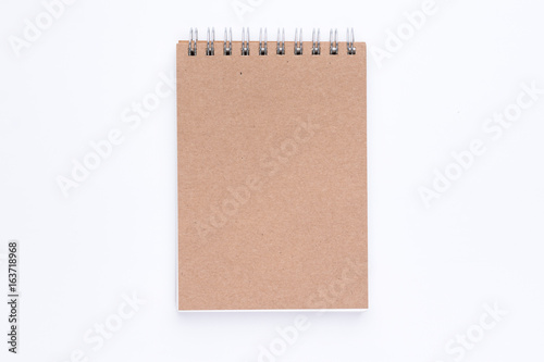 The top view of brown cover spiral notebook on white background