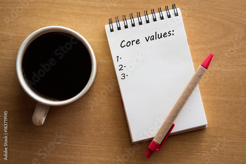 core values list on notebook with a pen and coffee - business ethics and mission concept
