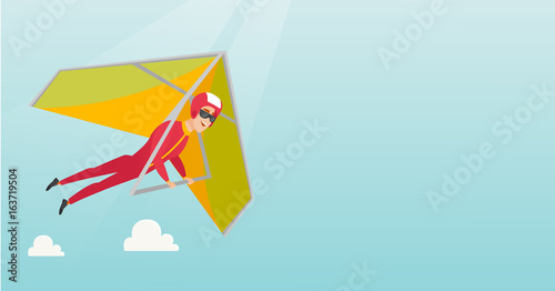 Young caucasian man flying on hang-glider.