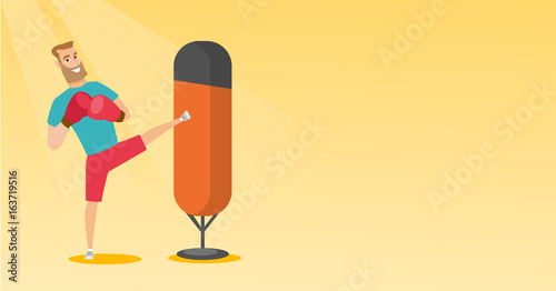 Young caucasian man exercising with punching bag.