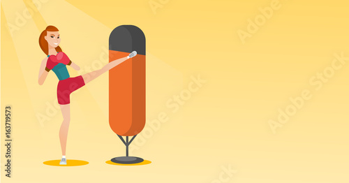 Young caucasian woman exercising with punching bag