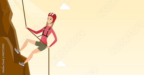 Caucasian woman climbing a mountain with rope.