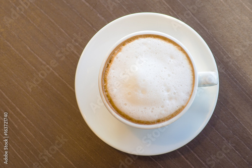 Flat view hot coffee in white cup on the wooden table lifestyle