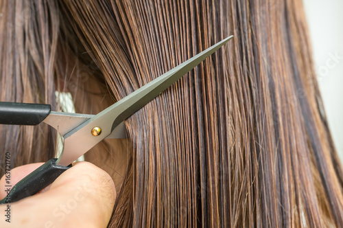 Straight wet hair with comb and scissors - hair care concept